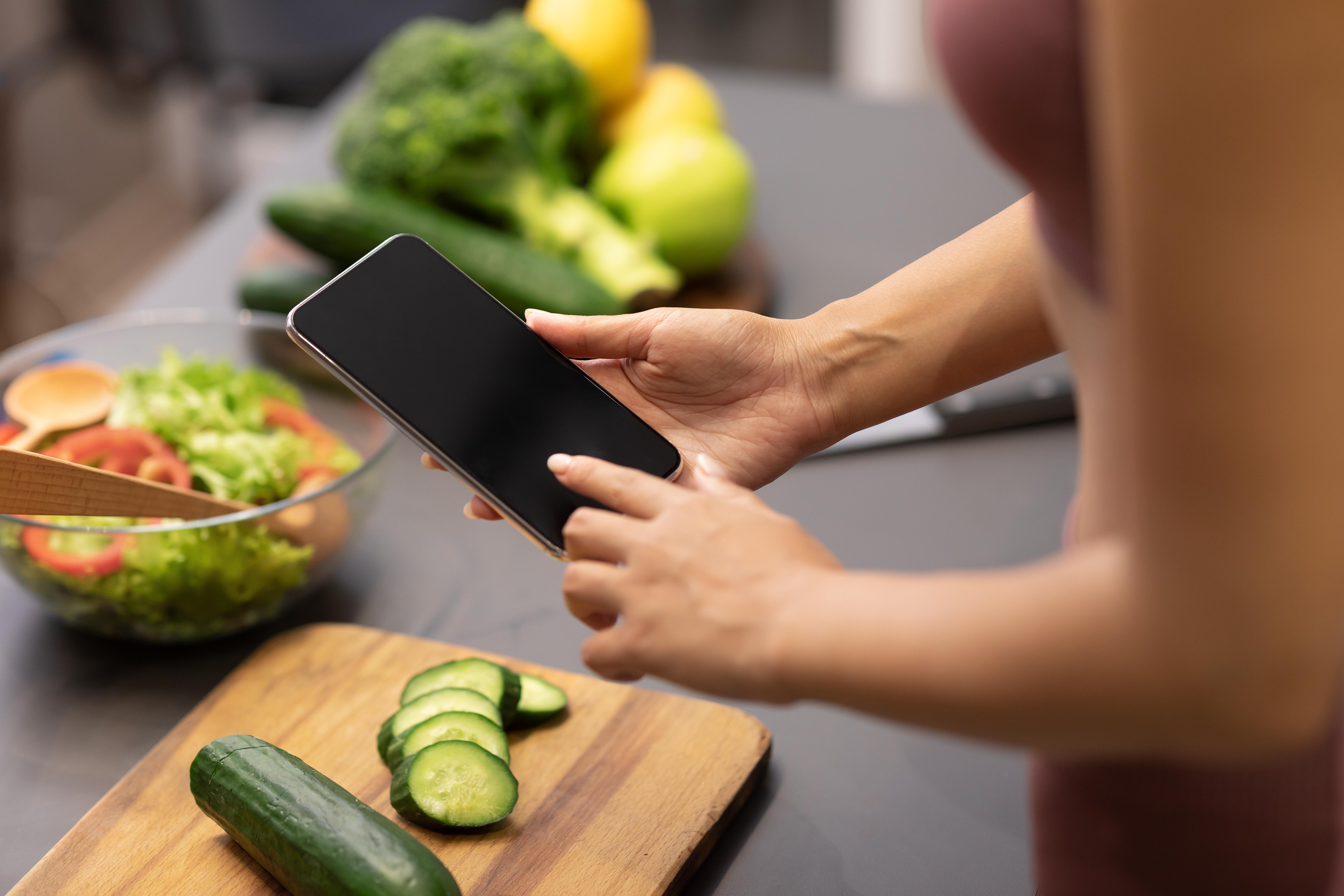 Lady using phone to search for recipes for weight loss