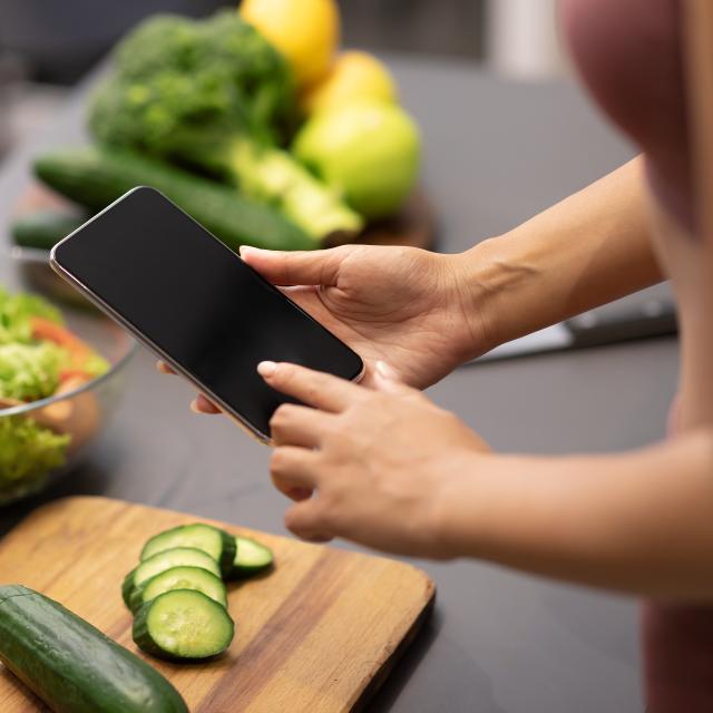 Lady using phone to search for recipes for weight loss